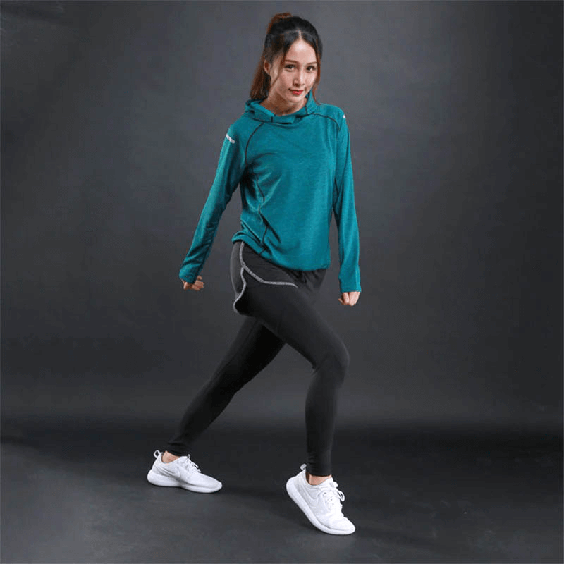 Woman wearing Sports Women's Thin Long Sleeves Hoodie with reflective printing, in teal, demonstrating a fitness pose.